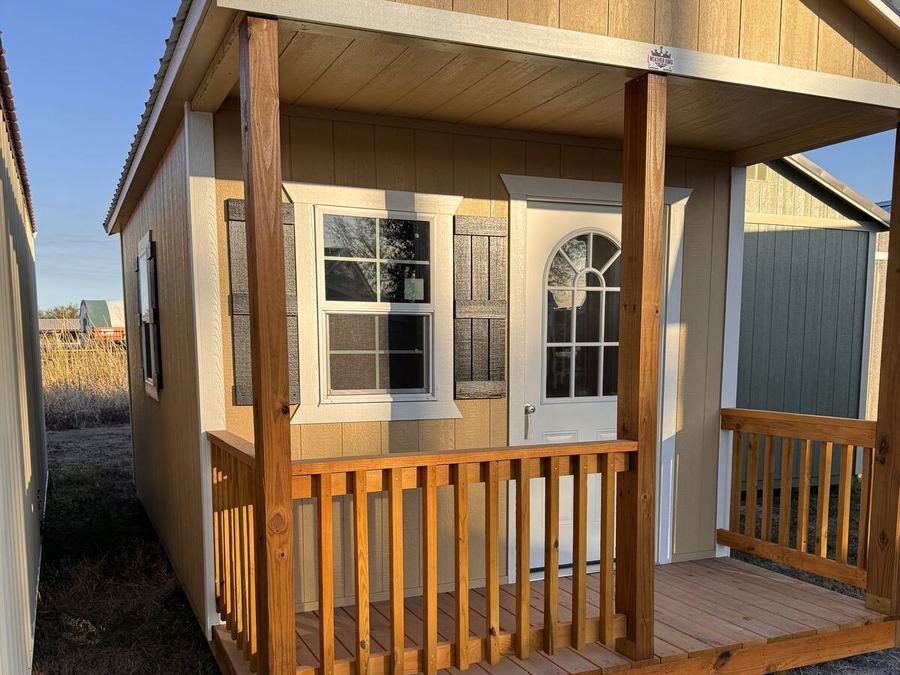 Cabin with covered front porch and railing
