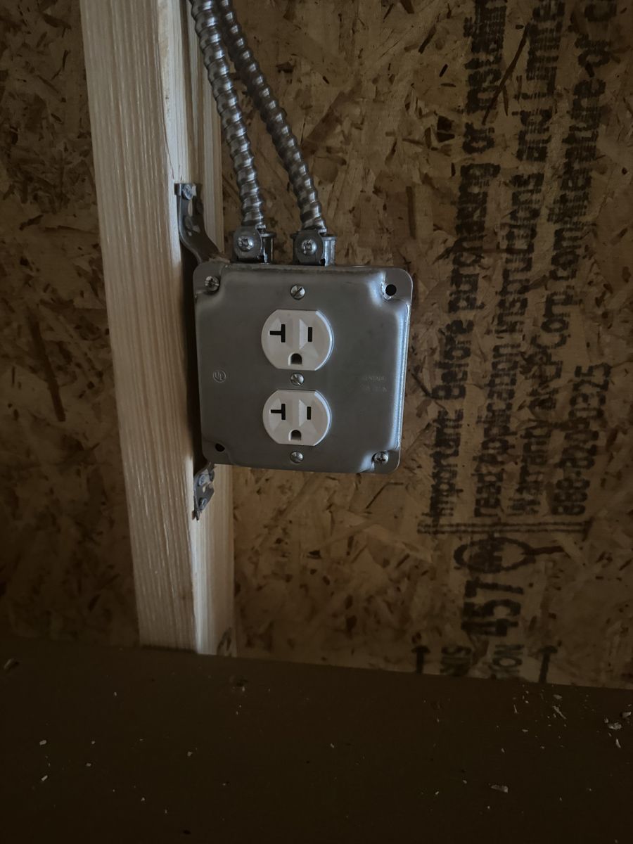 An outlet, wired in metal conduit
