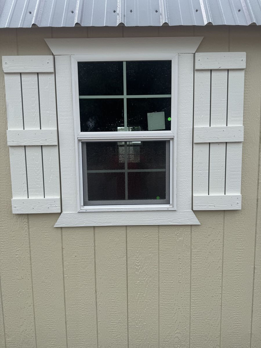 A set of shutters either side of a window