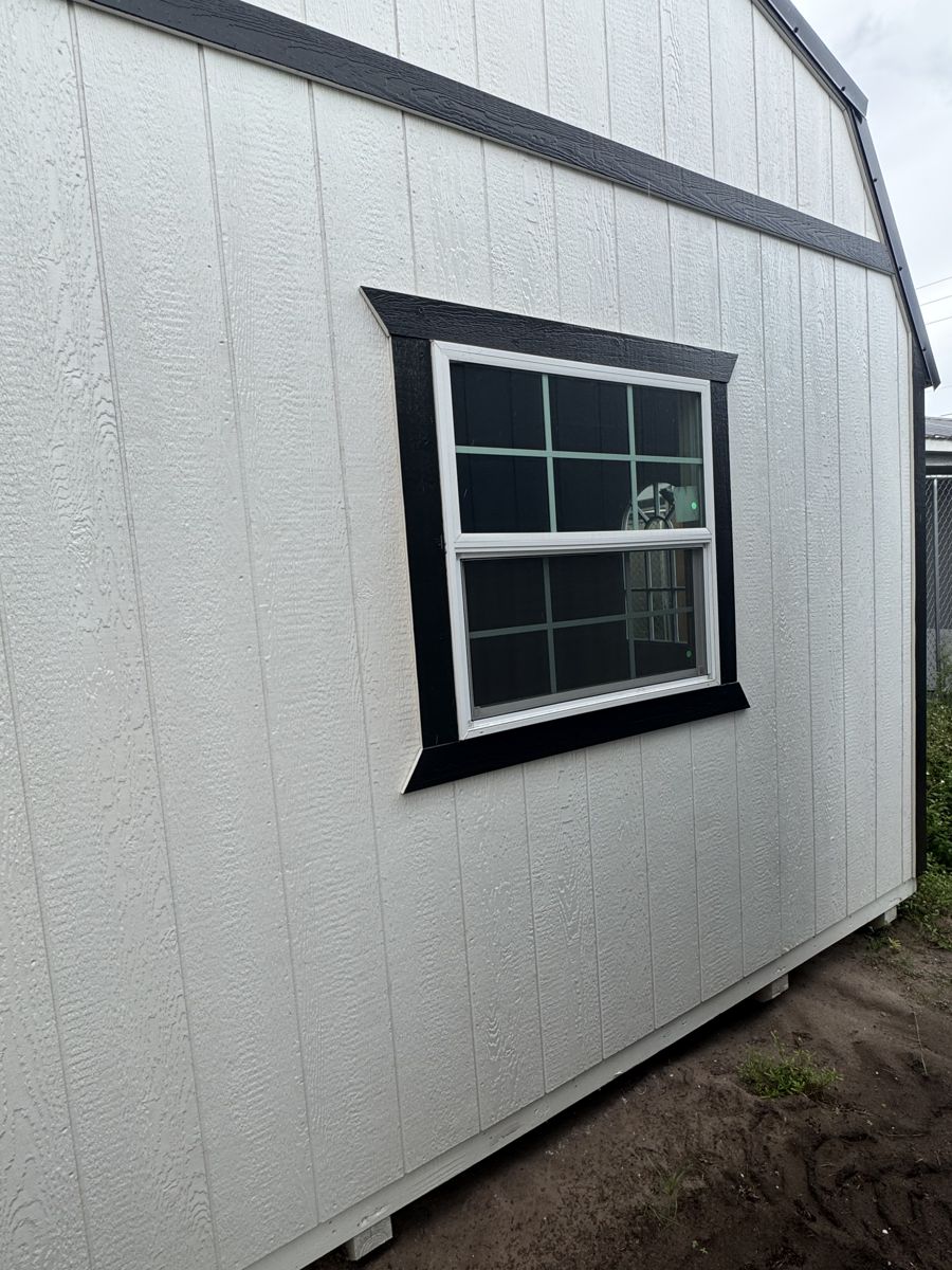 The same window on a white barn