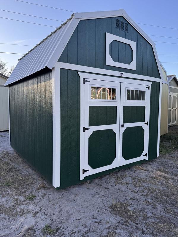Green lofted barn with white trim