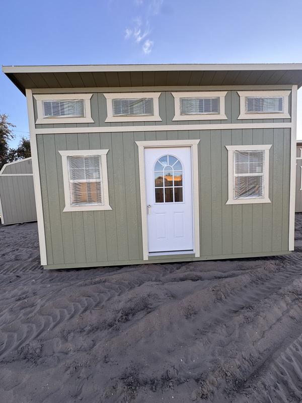 Sage green single slope shed with transom windows